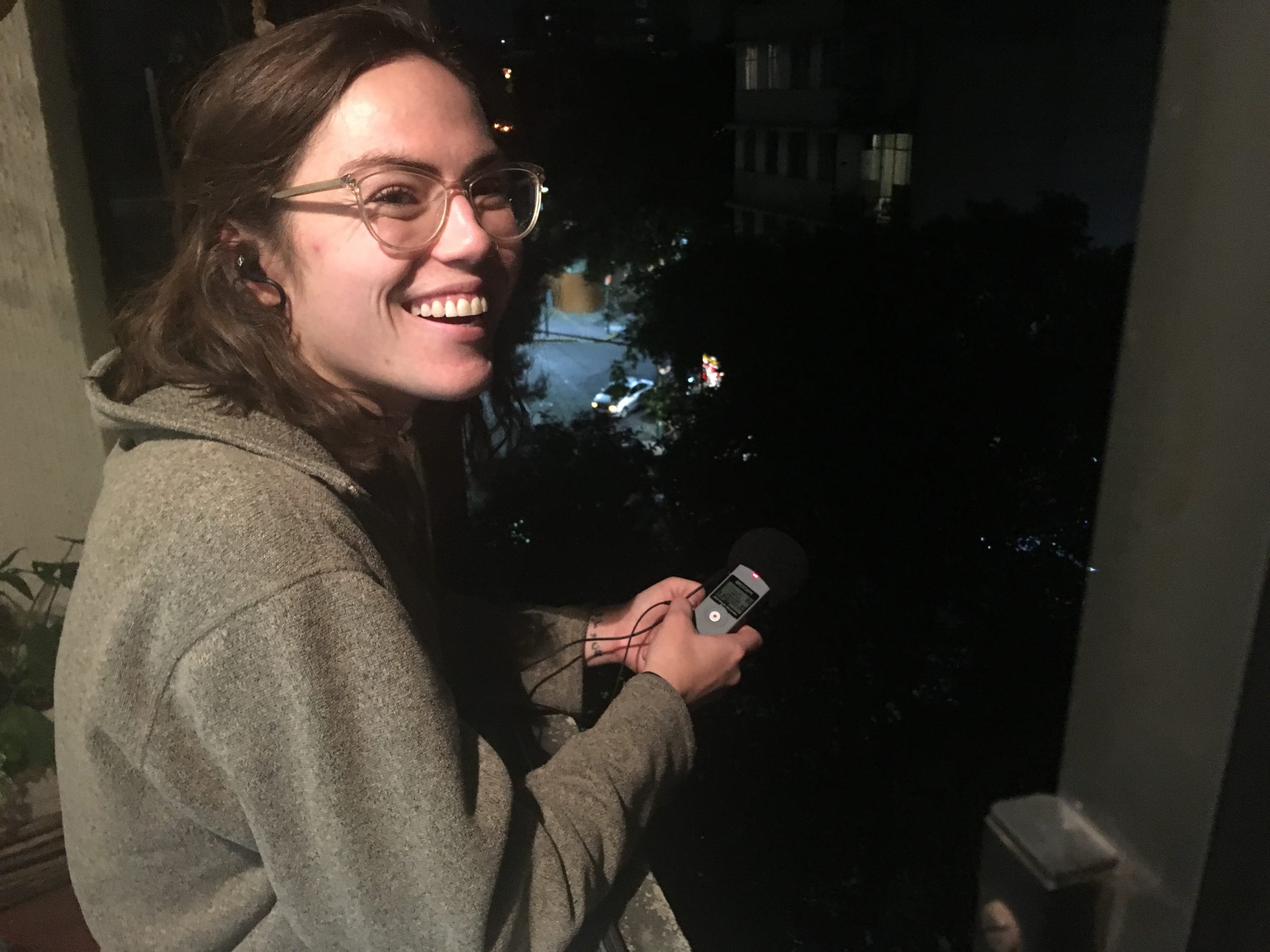 An image of Elizabeth Bynum holding an audio recorder.