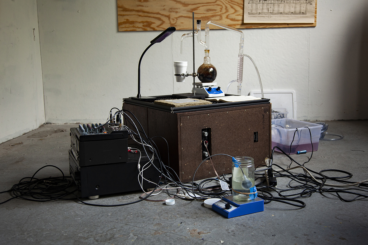 Science experiment on desk in middle of bare room