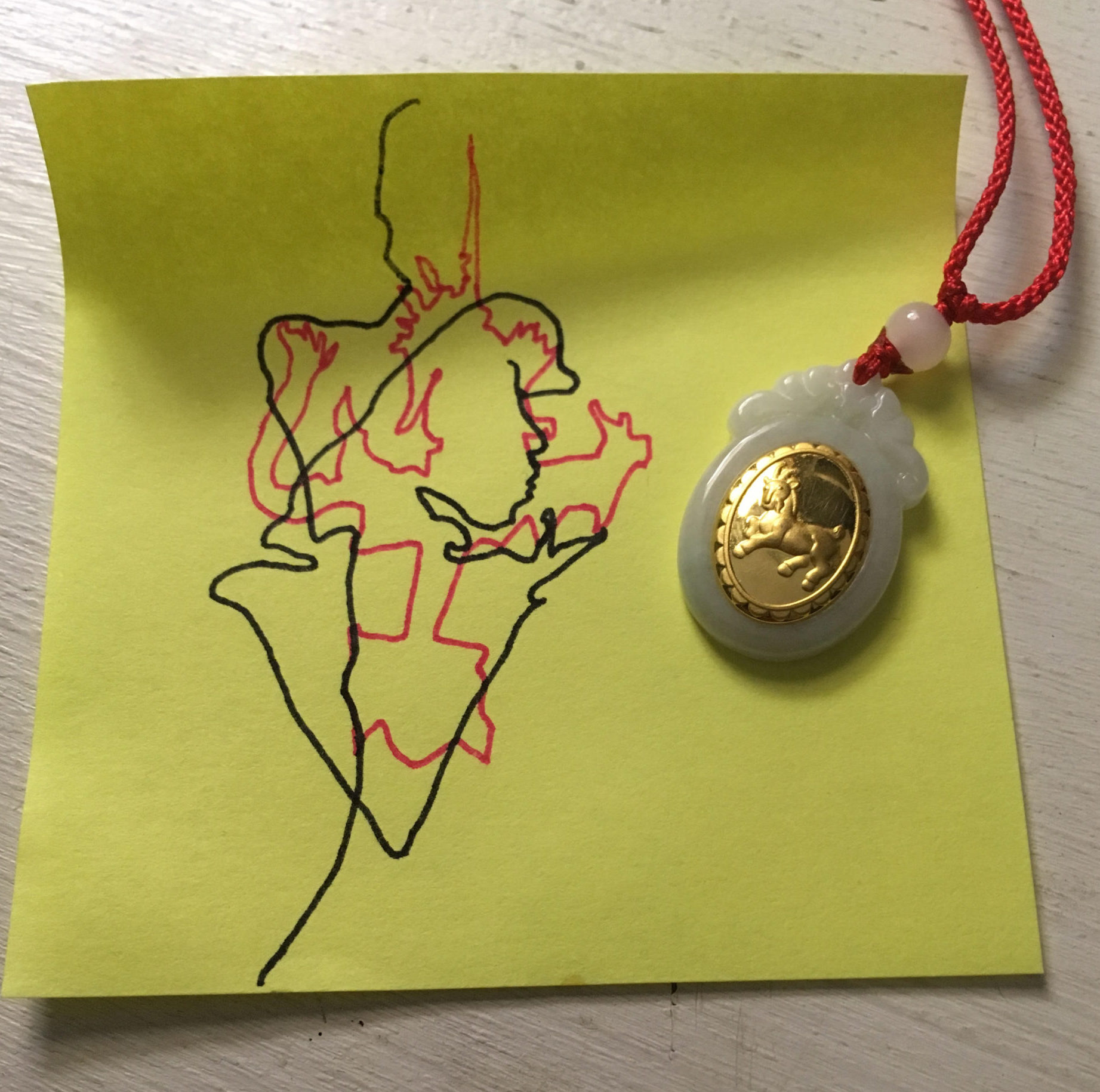 Abstract drawing with gold pendant on top