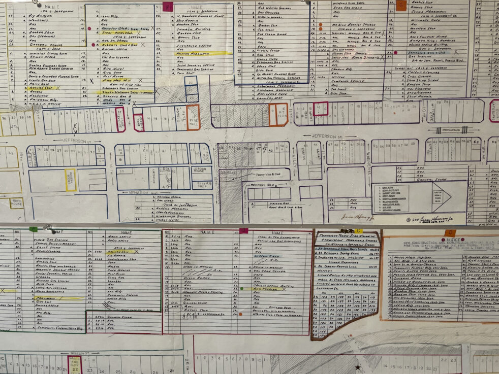 A detailed historical city block map with handwritten annotations and color-coded sections.